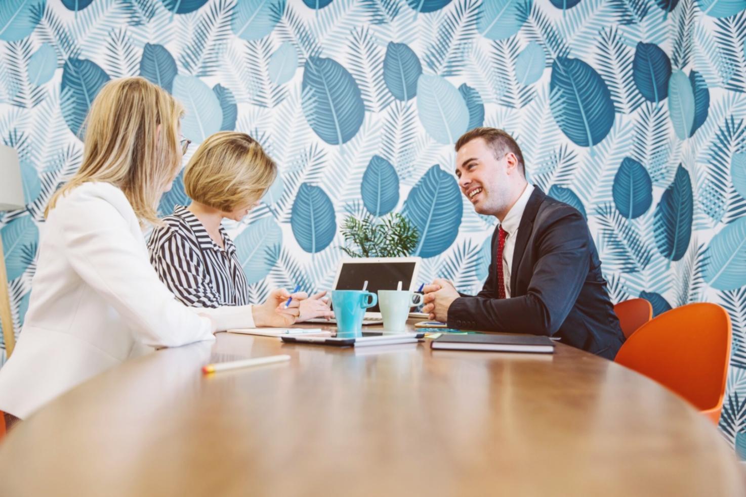 Professional presenting budget analysis to engaged team members in modern meeting space